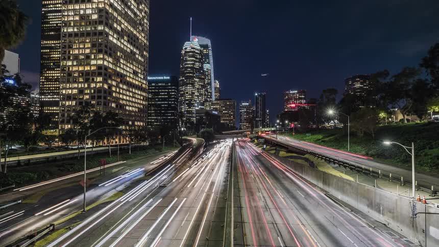 Traffic passing along an urban highway at night
