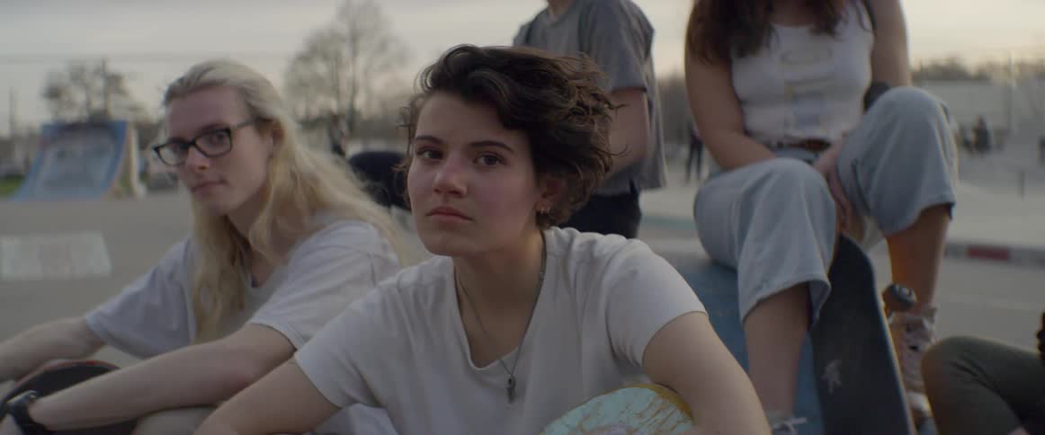A group of teens sitting outside