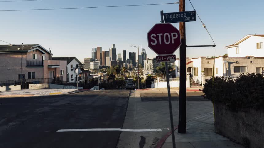 Cars drive on a city street