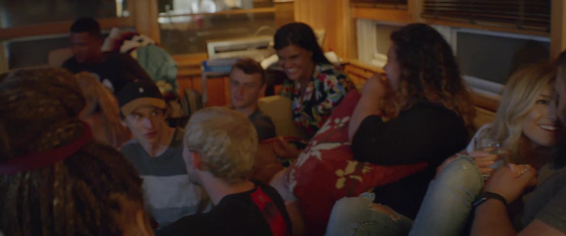 A group of people sit in the living room together