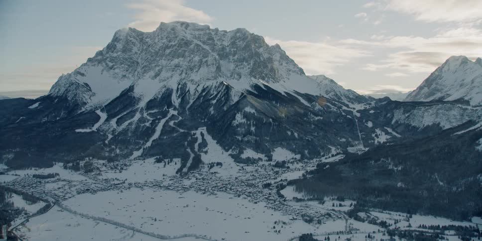 Sun shines down over snowy mountains