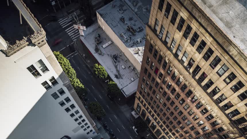 Traffic travels down a busy city street