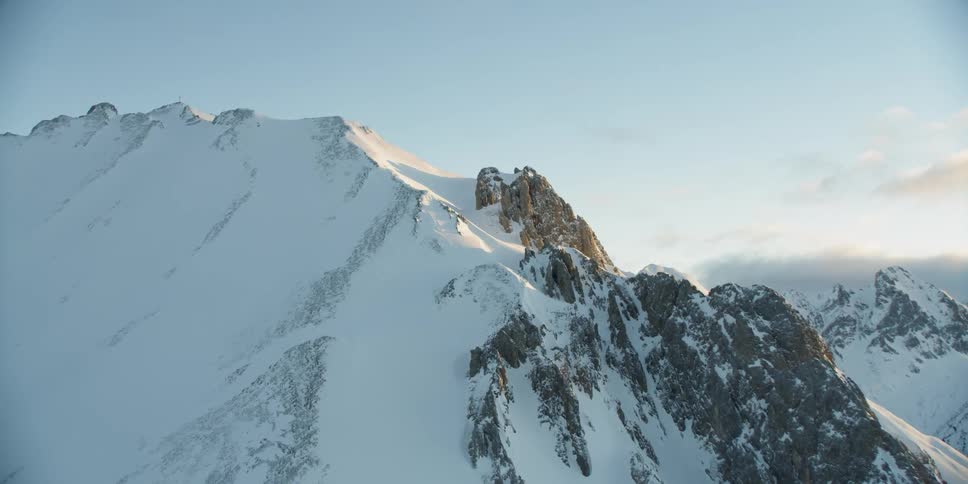 The mountain is tall and covered with snow