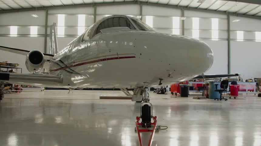 White airplane in a large airplane garage