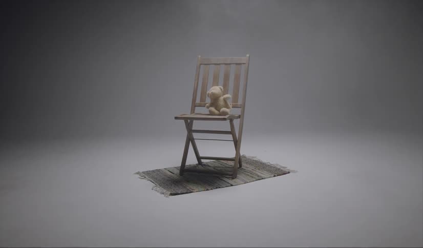 The chair sits on a small carpet with a teddy bear on top