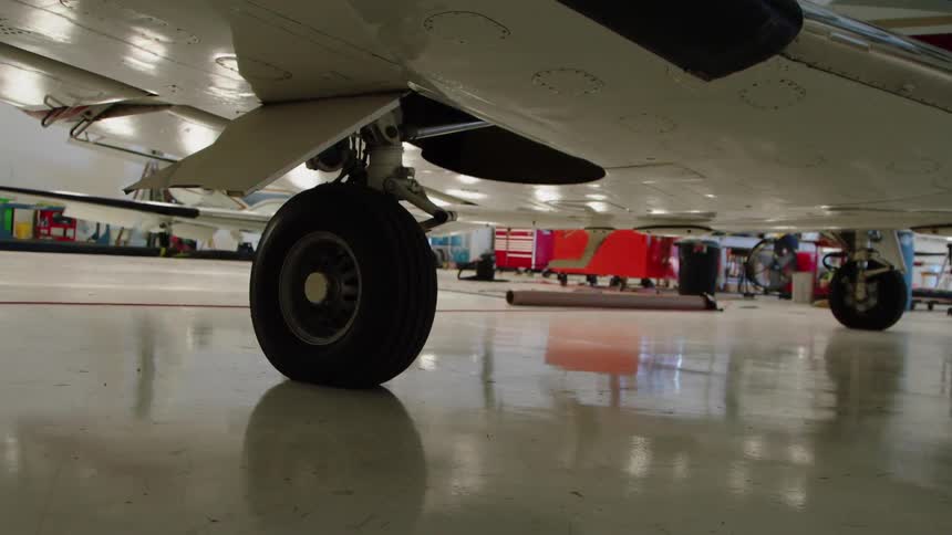 An airplane sits in a hangar