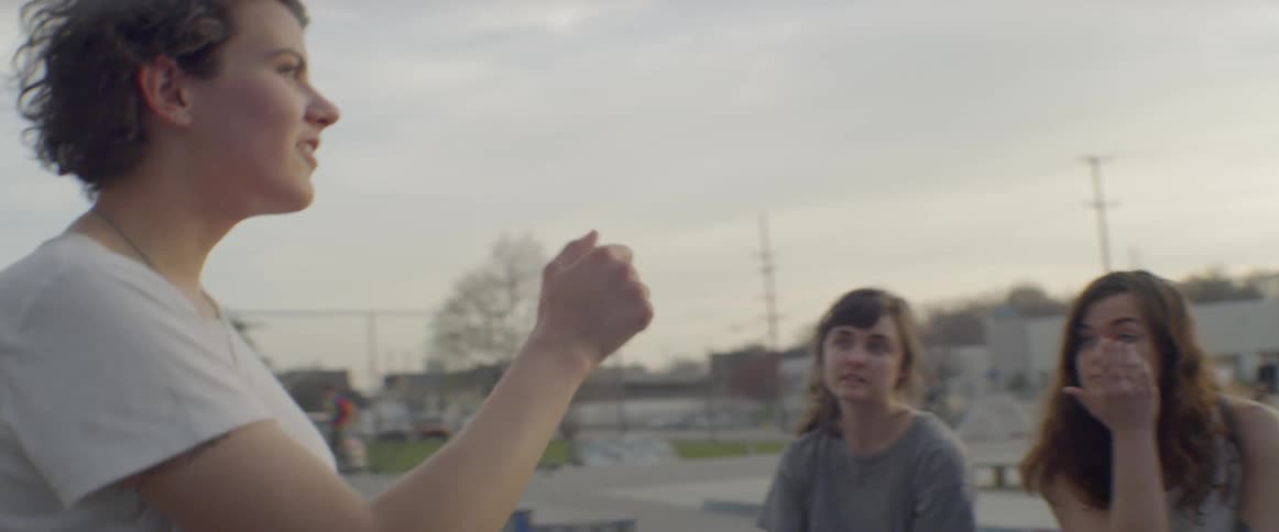 Group of young people at a skateboard park on a cloudy day