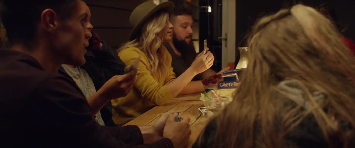 People are playing cards together at night