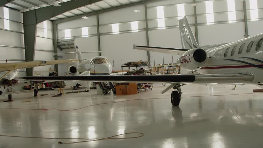 The plane has long wings in the hangar