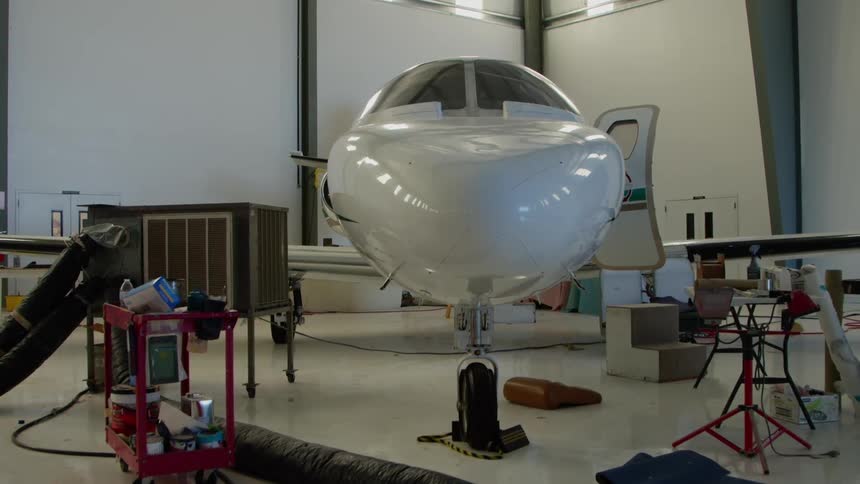 Airplane in a hangar that appears to be being worked on