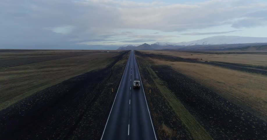 The vehicle travels down the long small road