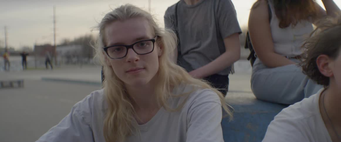 People sit together in a skate park