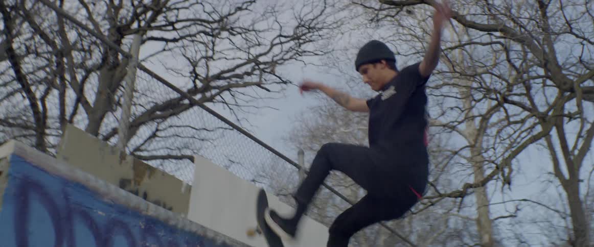 People are skating in the park on a cloudy day