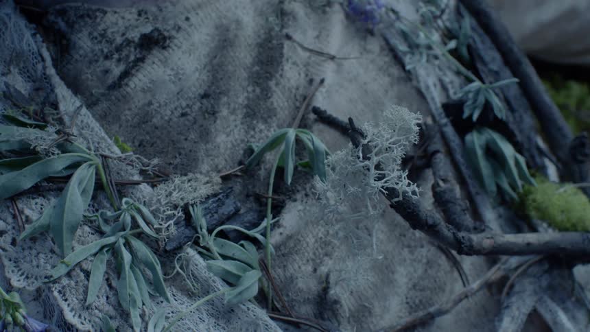 The person is covered with dirt and leaves