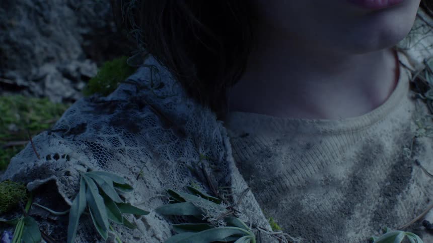 The person is covered with leaves and dirt