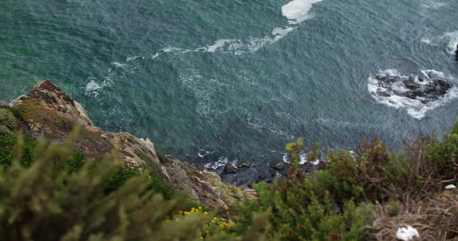 Waves crash on the side of a mountain
