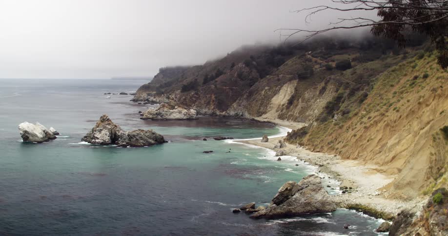 A beach with cliffs and rocks