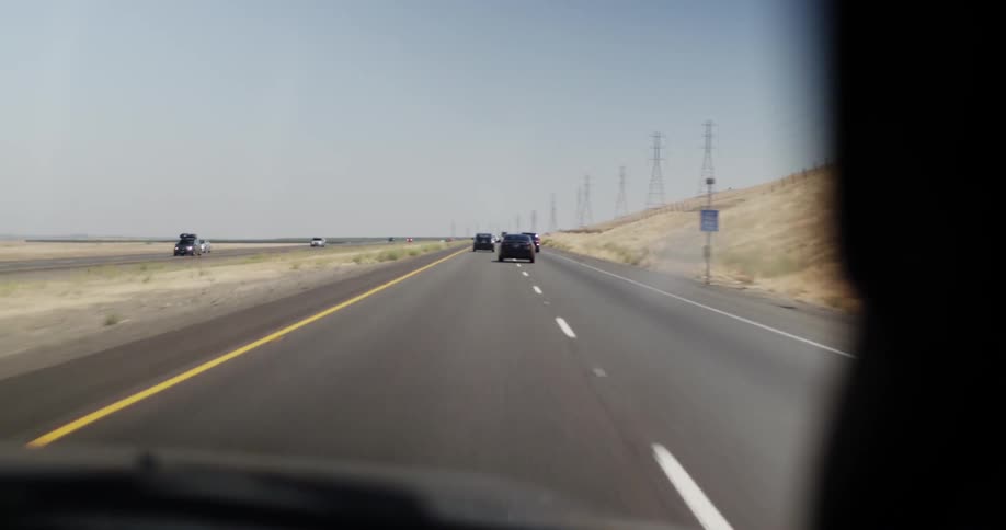People driving down a road on a cloudy day