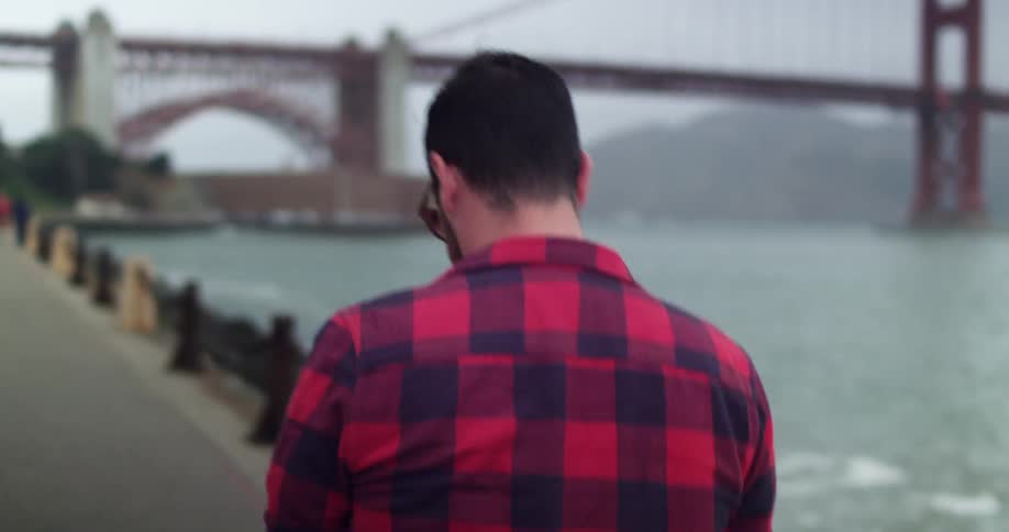 Man walks along Golden Gate Bridge viewpoint