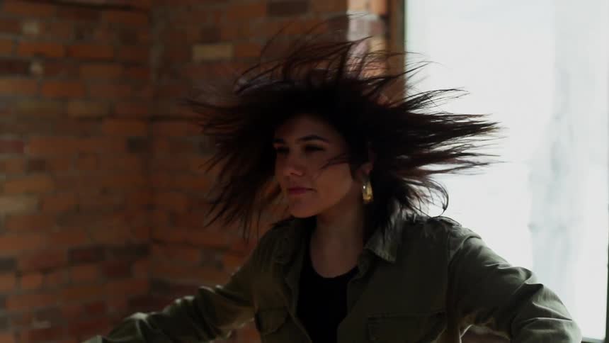 Woman  twirling around waving her hair