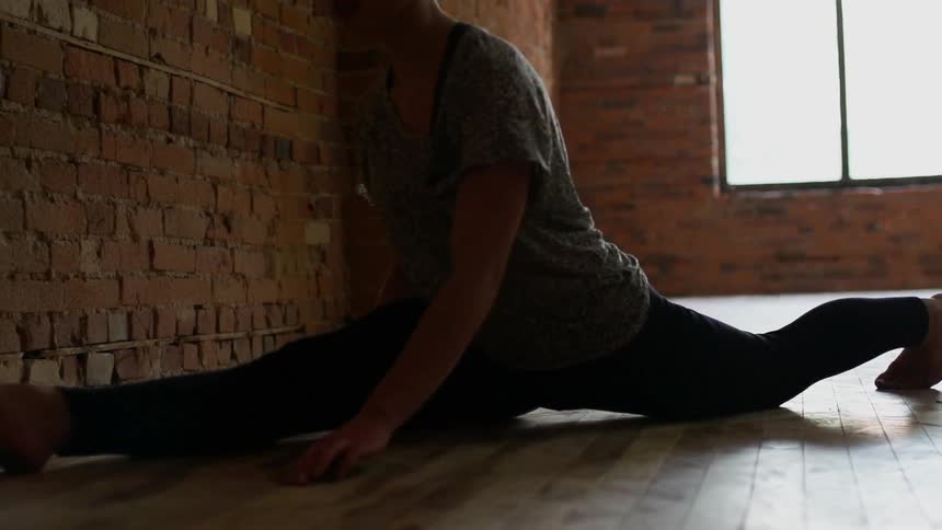 Person does a split on a wood floor