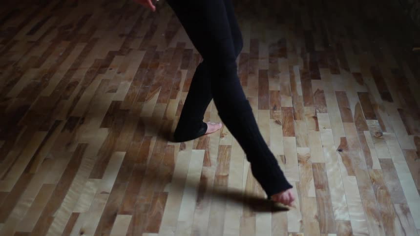 Someone is dancing on a wooden floor