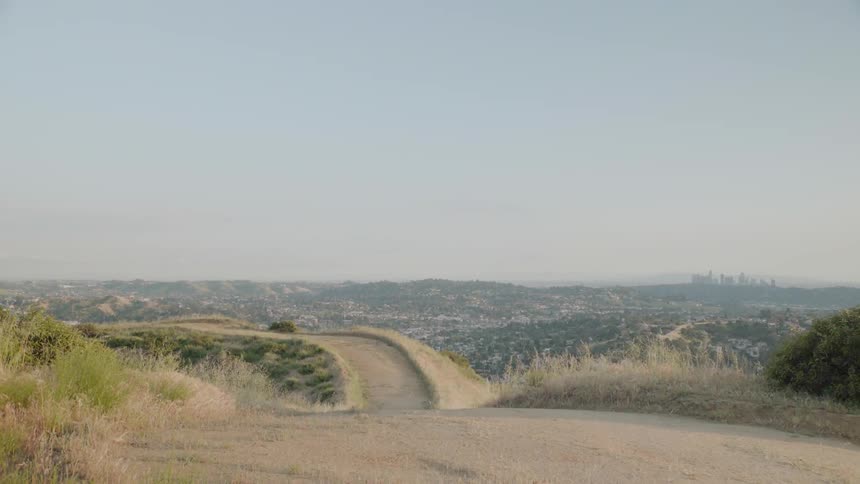 A dirt pass crosses the top of a mountain