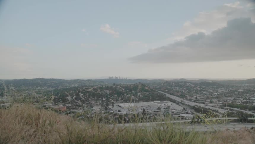 People travel by car on the highway by the town below