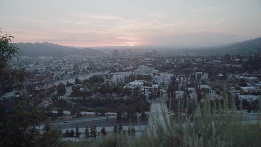 The sun sets over a city