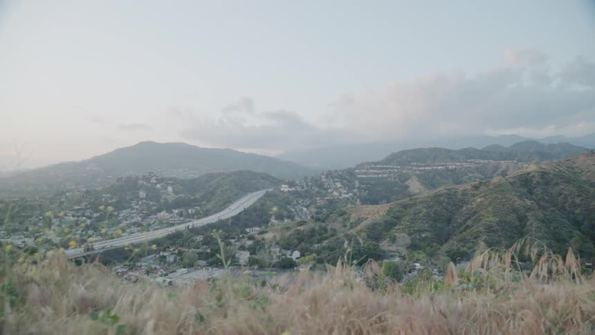 The fog rolls over the hills by the town ahead