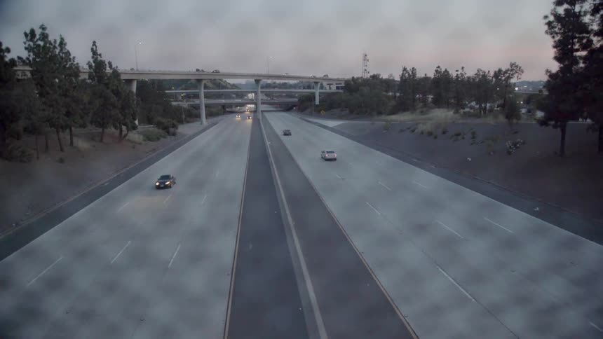 Vehicles travel along a 8 lane highway