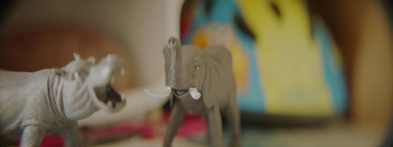 Animal figurines are displayed on a bedroom table