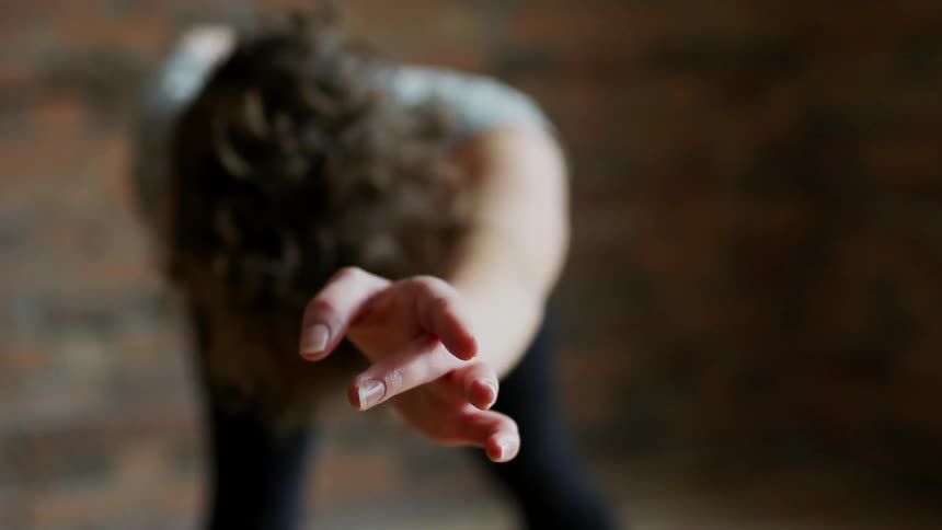 Woman stretching her arm into the air above her