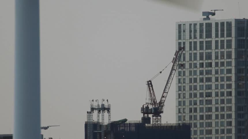 The windmill blade spins in front of the building