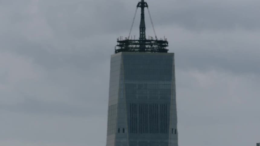 A large bird flies towards a skyscraper