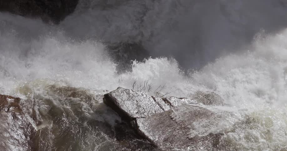 The water crashes against the rocks