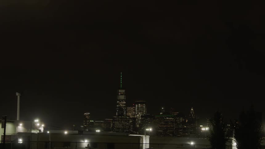 The buildings ahead are brightly lit at night