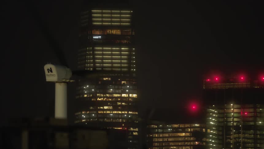 The windmill spins near the building