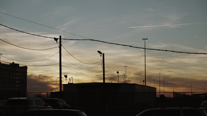 The power lines run over the buildings at dawn