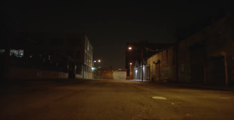 Warehouses are lit up by street lights at night