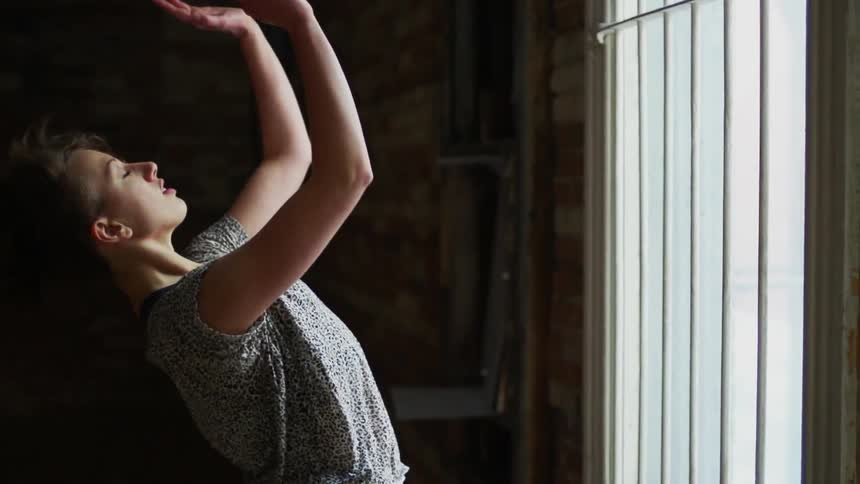 A woman runs towards the barred window and stops suddenly