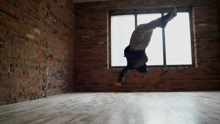 A person break dancing indoors