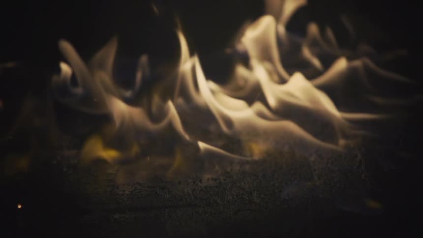 Close up of fire burning and sparks falling