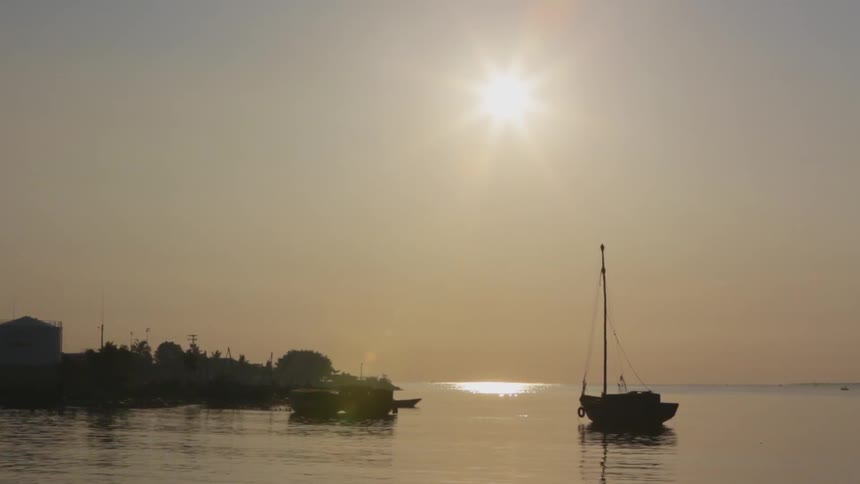 Two boats are anchored in the water on a cloudy day