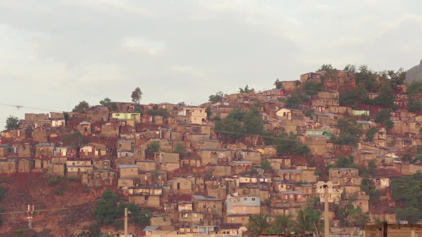 Aerial view of homes built over a hill on a cloudy day