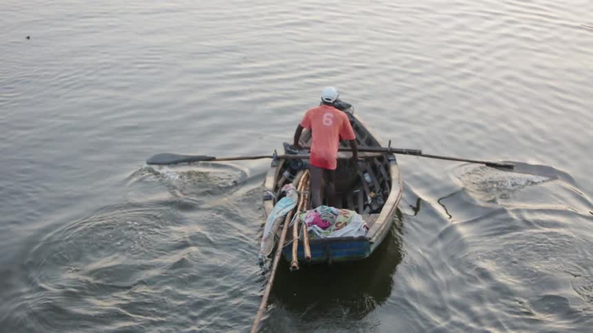 Man rowing a boat across some water