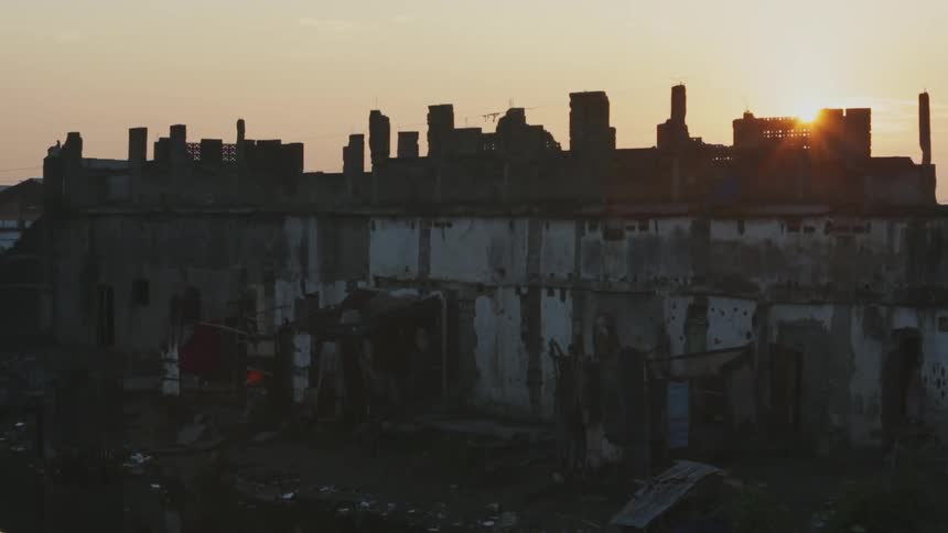 View of a dilapidated building at sunrise
