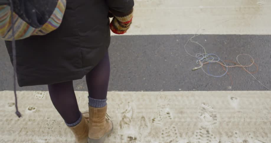 A woman walking through a crosswalk
