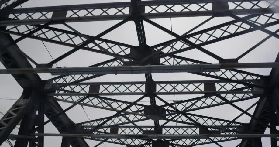 Metal beams loom overhead