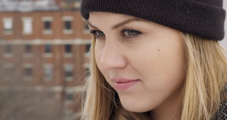 Close up of a woman's face with a building in the background
